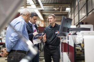 A member of Mark Andy's dedicated service and support team, speaking with customers about their equipment.