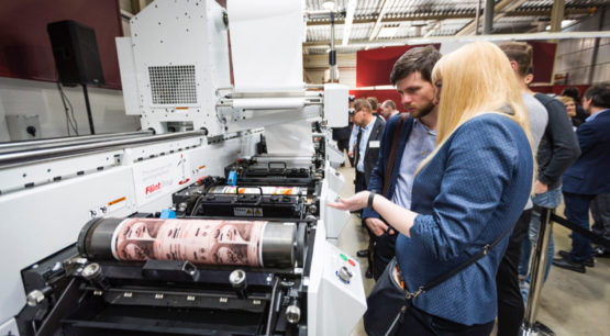 Group of people viewing Mark Andy printer