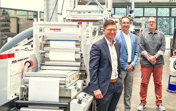 Members of Mark Andy and Barthe Group in front of Mark Andy press